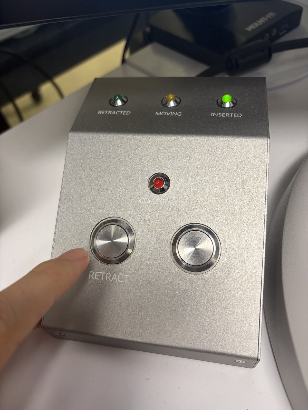 Arina hand panel with Retract button pressed